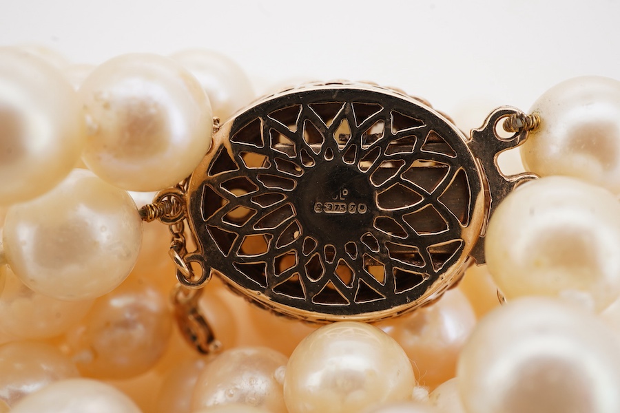 A double strand cultured pearl necklace, with a 9ct gold and cultured pearl cluster set clasp, pearl diameter approximate range 8.4mm-9mm.